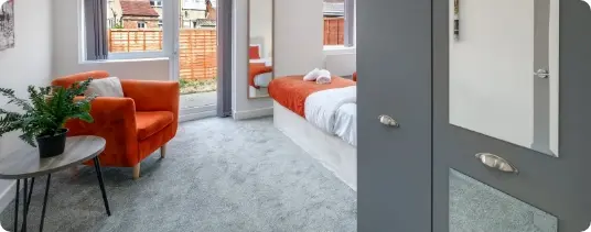 Bedroom with orange armchair