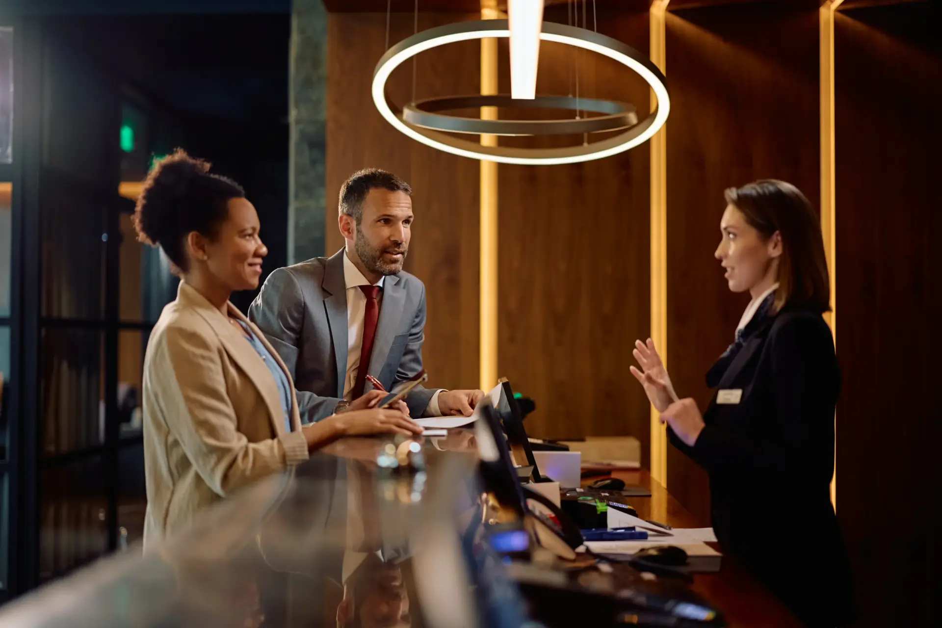 Guests talking to a hotel receptionist
